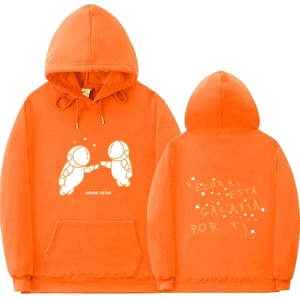 Detail of orange hoodie featuring cartoon astronauts and Spanish quote prints