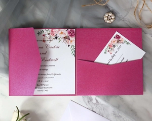 Detail of laser-cut magenta wedding invitation set with watercolor floral patterns