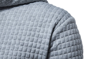 Close-up of grey hoodie featuring high-quality waffle knit and quilted square texture