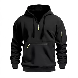 Detail of black hoodie featuring neon yellow zipper pulls and utility chest pockets