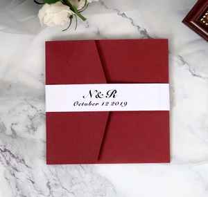 Macro detail of dark red square wedding invitation with custom printed belly band