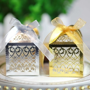 Detail of laser-cut European floral pattern on gold and silver wedding candy boxes