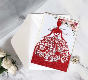 Détail de l'invitation de mariage rouge pailleté avec découpe laser et motif floral