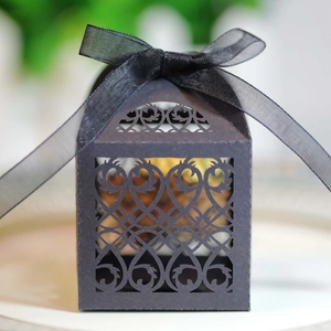 Detailed view of black laser-cut floral wedding gift box with elegant silk ribbon bow