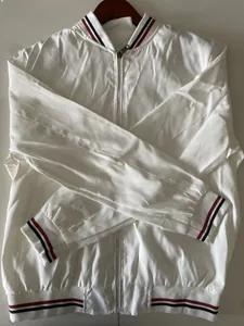 Detailed view of white lightweight bomber jacket with red white and blue striped ribbing