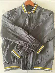 Detailed view of grey bomber jacket with yellow and white striped ribbed cuffs and collar