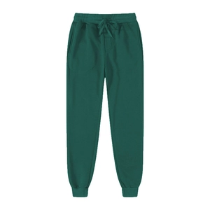 Detail of dark green joggers showing adjustable drawstring waistband and soft fabric texture