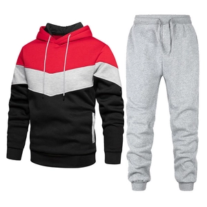 Men's sport tracksuit featuring a red, grey, and black color-block hoodie with grey joggers