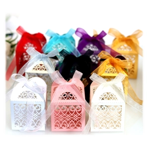 Elegant laser cut wedding favor boxes with heart patterns and ribbon bows in various colors