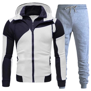 Men's two-piece tracksuit with navy patchwork zip-up hoodie and grey joggers