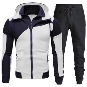Detail of men's slim fit tracksuit showing navy and white spliced hooded jacket and joggers