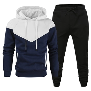 Detail of men's tracksuit set with white and blue color-blocked hoodie and black joggers