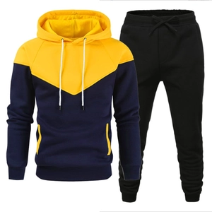 Men's two-piece tracksuit featuring yellow and navy contrast hoodie and black jogger pants