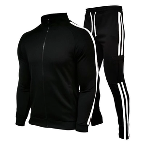 Detail of black tracksuit featuring white side stripes and utility cargo pocket