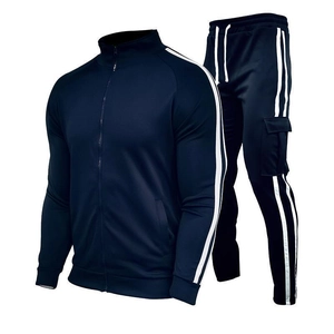 Detail of dark blue men's tracksuit featuring white side stripes and cargo pockets