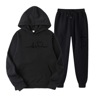 Detail of minimalist heartbeat heart pattern print on black fleece hoodie and jogger set