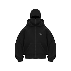 Detail of black hoodie featuring integrated balaclava mask and monster logo print