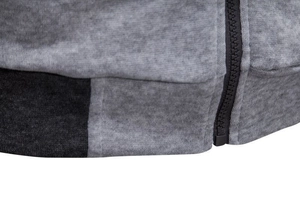 Close-up of color-block knit hoodie with ribbed hem and black zipper detail