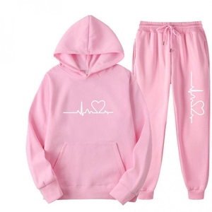 Close-up of pink hooded tracksuit featuring heart EKG wave print and ribbed cuffs