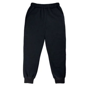 Detail view of elastic waistband and ribbed cuffs on thick black kids joggers