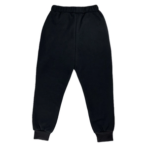 Detail view of black thermal sports trousers with elastic waistband and ribbed cuffs