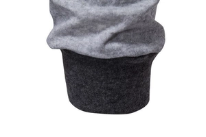 Detail of grey spliced men hoodie showing light grey knit fabric and dark grey ribbed cuff