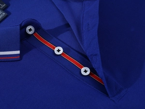 Macro shot of navy polo shirt with pique texture and red, white, blue striped placket