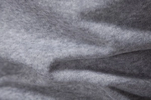 Close-up of premium gray heather fabric texture showing soft cotton blend fibers