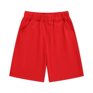 Close-up of red cotton kids shorts with elastic waistband and functional side pockets
