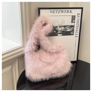 Detail of pink faux fur tote bag showing soft plush texture on a black mirror surface