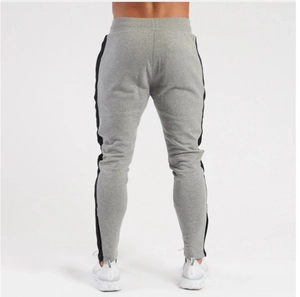 Detailed back view of men's slim fit grey joggers with black side stripes and elastic cuffs