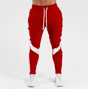 Detail view of red slim fit joggers with white side stripes and adjustable drawstring waist