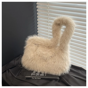 Detailed macro view of beige faux fur tote bag showing soft texture and circular handle