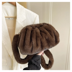 Détail du sac nuage en peluche marron sur un blazer blanc pour la mode automne-hiver