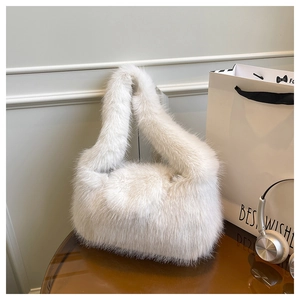Detailed macro view of the premium white faux fur texture on a plush tote bag for women