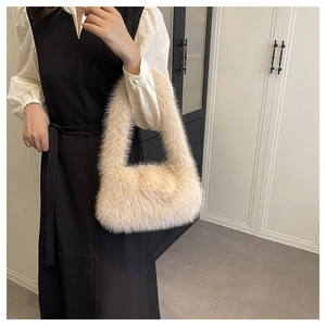 Detailed view of the soft beige faux fur texture and handle of the luxury tote bag