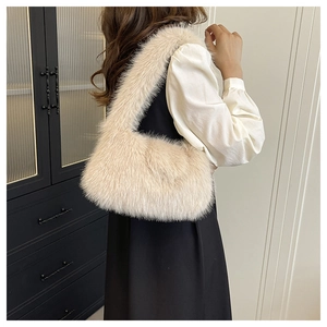 Detail of soft beige faux fur shoulder bag with plush texture and matching wide strap