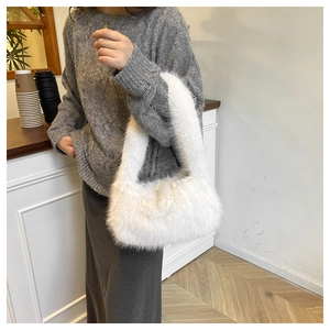 Close-up of white faux fur tote bag showing soft plush texture and integrated handle