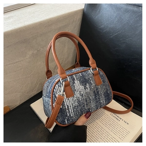 Close-up of denim mini Boston bag with silver sequins and brown PU leather trim