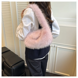Detail of pink faux fur hobo bag showing fluffy texture and integrated handle design