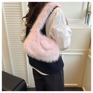 Detail of pink faux fur crescent shoulder bag showing soft plush texture and curved design