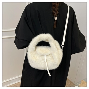 Detailed back view of a white plush faux fur crossbody bag with thin leather strap