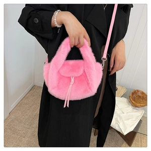 Detail of hot pink plush tote bag with furry texture and thin detachable shoulder strap