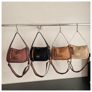 Detailed row of Boston bags in four colors with striped woven shoulder straps