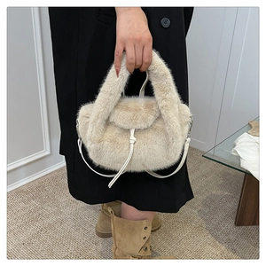 Detail of plush beige faux fur handbag with stylish white leather-like shoulder strap