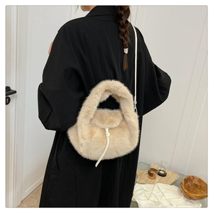 Detail of soft beige faux fur handbag with elegant white rope decor and metal strap clip