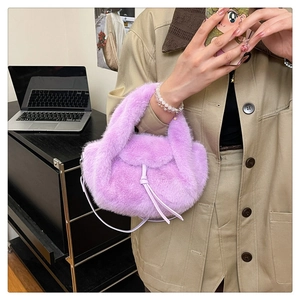 Detail of purple faux fur handbag with white drawstring bow and soft texture