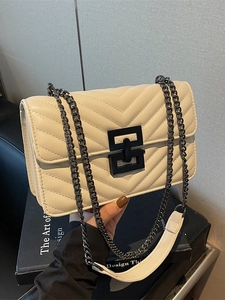 Minimalist white quilted shoulder bag with black chain strap and chevron pattern