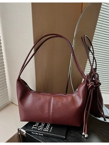 Retro burgundy crescent hobo bag with sleek leather finish and adjustable dual straps