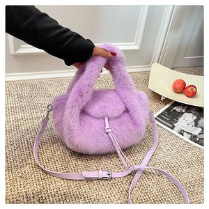Detailed close-up of lavender faux fur handbag with drawstring closure and leather strap